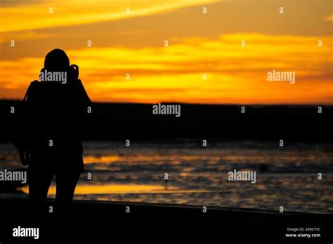 Silhouette Of Woman Watching The Sunset Hi Res Stock Photography And