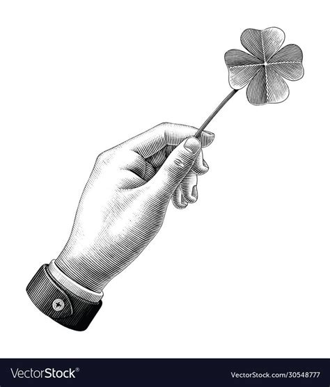 A Hand Holding A Four Leaf Clover