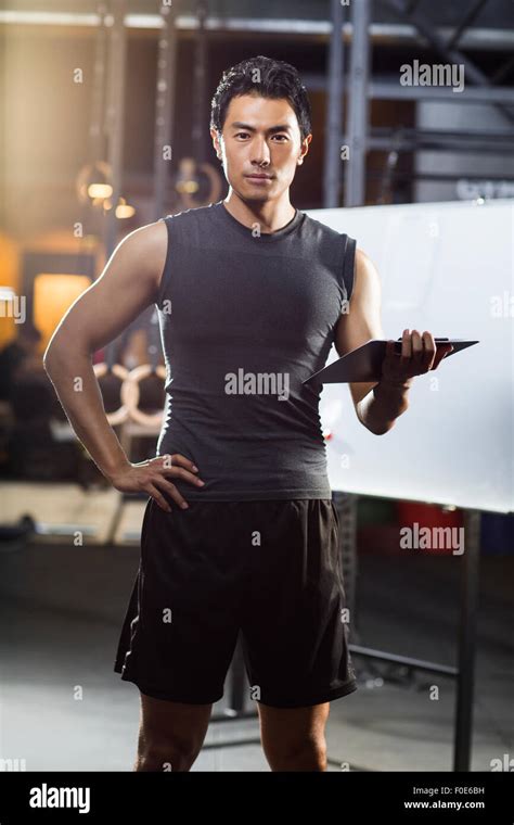 Coach making exercise plan in gym Stock Photo - Alamy