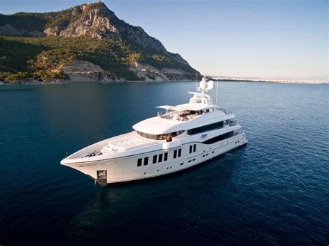 A Large White Boat Floating On Top Of The Ocean Next To A Rocky