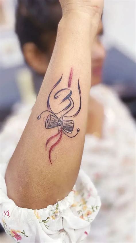 Trishul Om Damro Tattoo On Exterior Forearm Skin Machine Tattoo