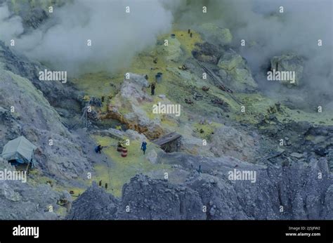 many workers at sulfur mining on volcano Stock Photo - Alamy