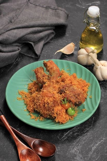 Premium Photo | Ayam serundeng indonesian traditional fried chicken recipe with shredded coconut