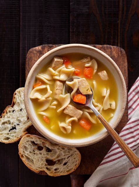 Overhead View Of Chicken Noodle Soup With Rustic Bread Stock Image