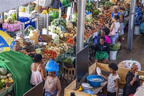 Stalls With Fresh Fruit And Vegetables For Sale At Busy Indoor Food