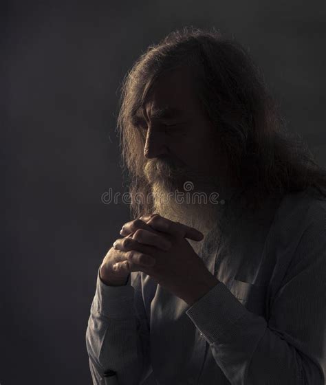 Senior Prayer Old Man Praying With Folded Hands In Dark Stock Image