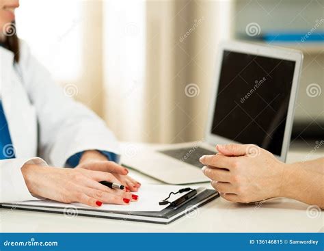 Close Up Of Woman Doctor And Patient Having Consultation In Hospital