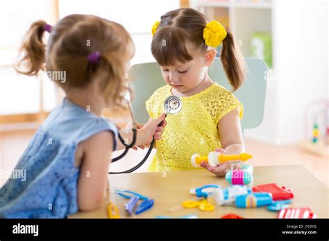 Two Cute Children Play Doctor And Hospital Using Stethoscope Friends