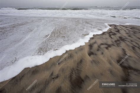 Waves Lapping On Shore On Sandy Beach Nature Non Urban Scene