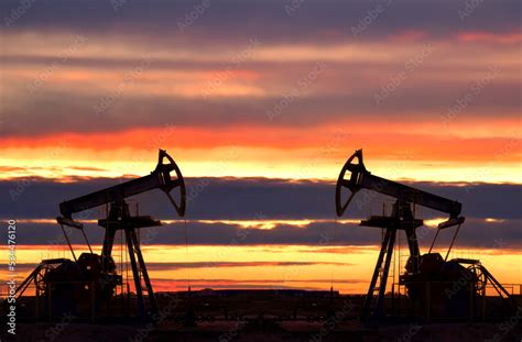 Crude Oil Pump Jack At Oilfield On Atmospheric Sunset Backround Fossil