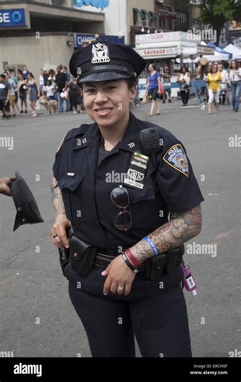 Female NYPD cop with tattoos showing down her arms on a warm spring day ...