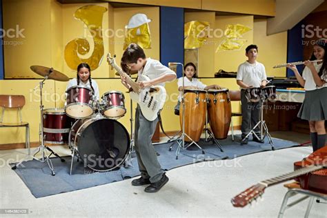 Elementary Students Playing Instruments In Music Room Stock Photo ...