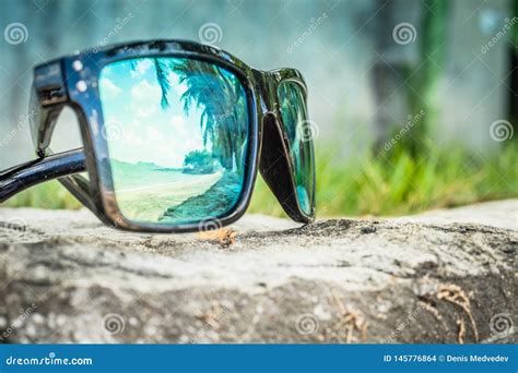 Fashionable Sunglasses Sunglasses With Mirrored Lenses Reflection Of The Beach And Tropical