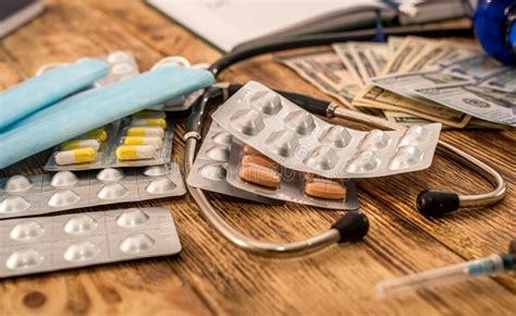 Pills With Dollar Bills Stethoscope Syringe Arranged On A New Table