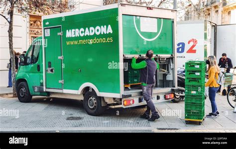 Valencia, Spain - May 2021. Mercadona delivery truck parked on the street with the delivery man ...