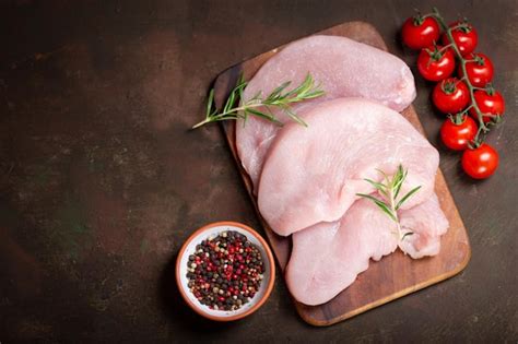 Premium Photo Fresh Turkey Meat Steaks With Rosemary Top View