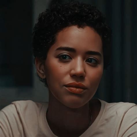 a close up of a person wearing a white shirt and orange lipstick on her ...