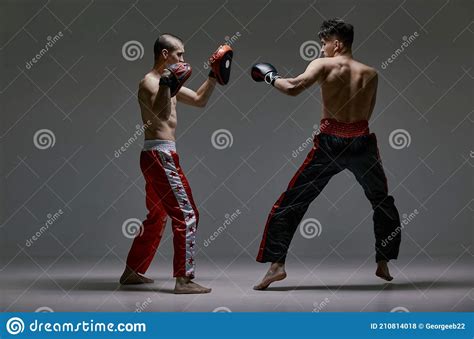 Athletic Males In Boxing Gloves Training Martial Arts Technique Fighting Guys During Mixed