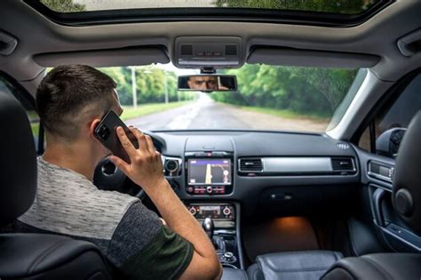 Premium Photo Businessman Talking On Cell Phone While Driving