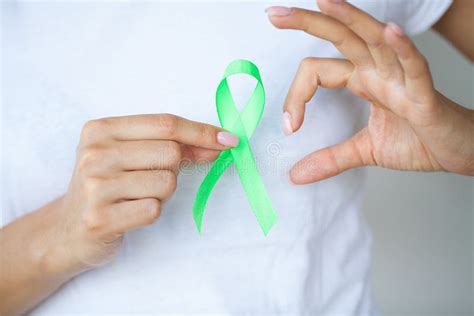 Doctor in Uniform Holds a Green Ribbon As a Symbol of Lyme Disease Stock Photo - Image of cancer ...