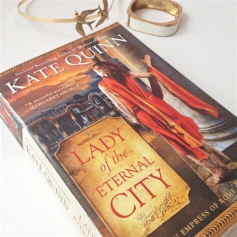 The Lady Of The Eternal City Book Is Laying On Top Of A White Tablecloth