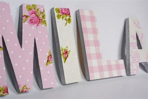 The Word Mum Spelled With Pink Flowers And White Polka Dots On A Light