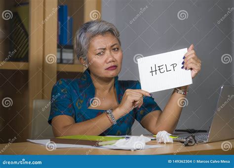 Desperate And Stressed Attractive Middle Aged Asian Woman Holding