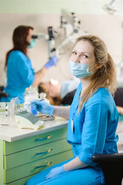 Portrait Of Young Woman Dentist Assistant Holding Dental Tool Stock