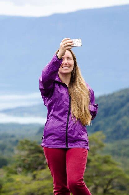 Premium Photo Woman Taking Selfie Through Mobile Phone While Standing