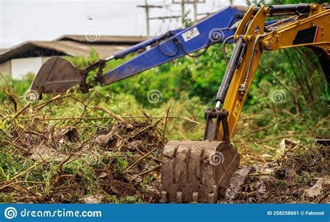 Backhoe Digging Soil At Construction Site. Bucket Of Backhoe Digging Soil. Clearing And Grubbing ...