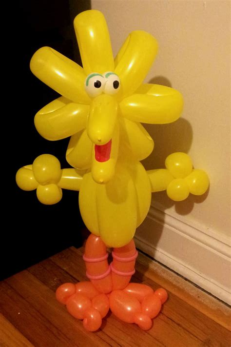 an inflatable banana standing on its hind legs and holding two hands ...