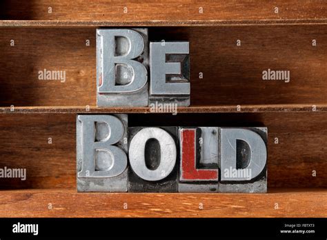 Be Bold Phrase Made From Metallic Letterpress Type On Wooden Tray Stock