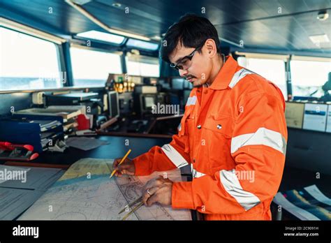 Filipino Deck Officer On Bridge Of Vessel Or Ship He Is Plotting