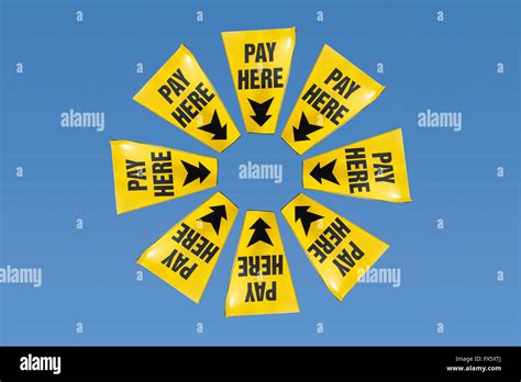 Yellow Pay Here Signs Pointing To The Centre Stock Photo Alamy