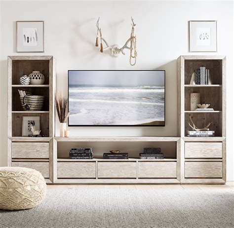 A Flat Screen Tv Sitting On Top Of A Wooden Entertainment Center In A