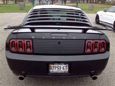 Black 2007 Ford Steeda Mustang Gt With Silver Horse Racing Rear Quarter