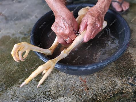 Premium Photo | Butcher cleaning the slaughter chicken for sale