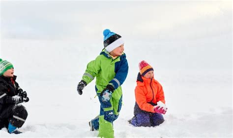 Premium Photo | Happy little kids playing outdoors in winter