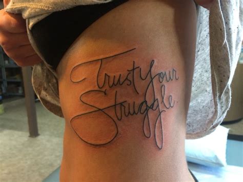 A Woman With A Tattoo That Says Trust Your Struggle On Her Side Ribcage