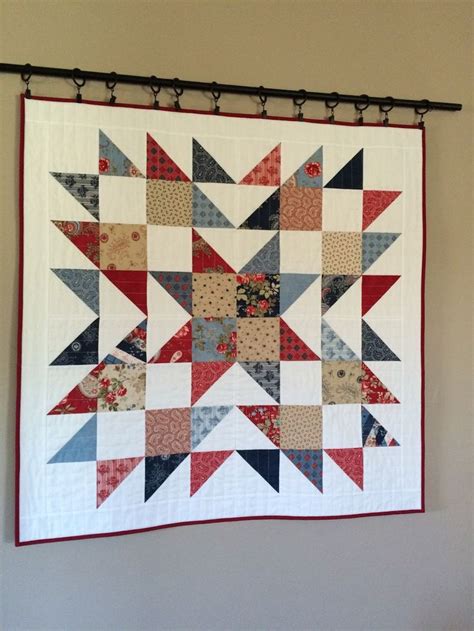 A Large Quilt Hanging On The Wall