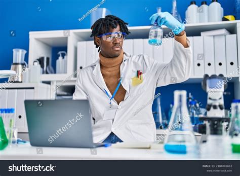 African American Man Scientist Using Laptop Stock Photo