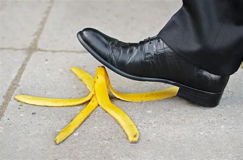 Businessman About To Slip And Fall On A Banana Skin Stock Image