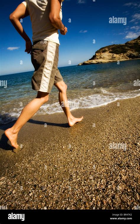 Barefoot woman running on beach, Crete, Greece Stock Photo - Alamy