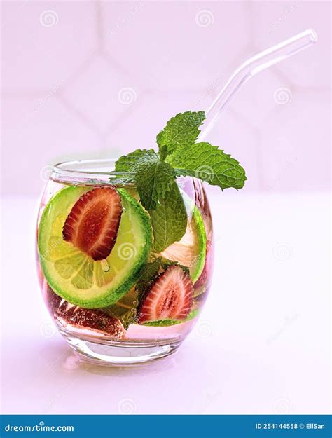 Vertical Shot Of Cold Fresh Summer Drink In Glass With Straw Tasty Beverage With Sliced Lime