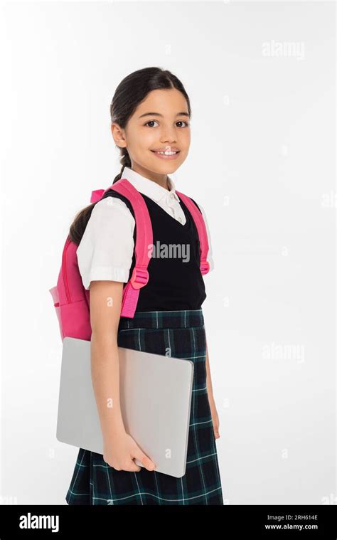 Positive Schoolgirl Holding Laptop And Looking At Camera Girl In