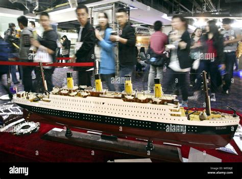 Moviegoers look at a model of the Titanic ship before watching the 3D ...