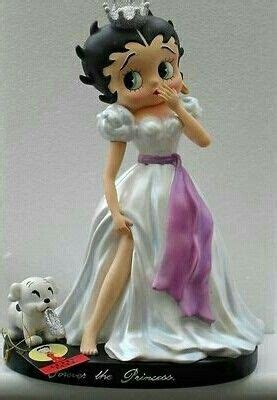 A Figurine Of A Woman In A White Dress