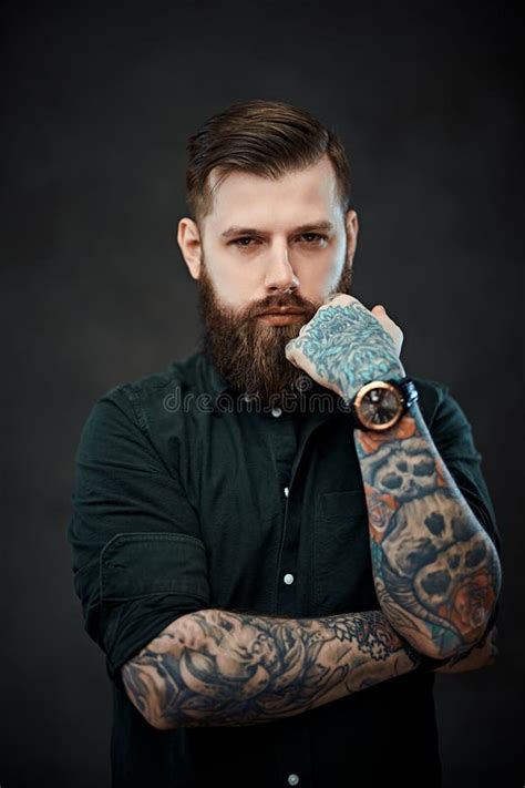 Handsome Bearded Man with Tattoos on His Hands Looks at the Camera with a Thoughtful Look Stock ...