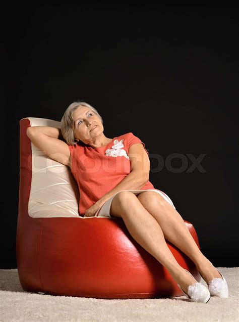 Elderly Woman Sitting On Armchair Stock Image Colourbox