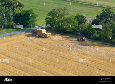 Aerial View Of Tractor Collecting Straw Bales Agricultural Machine